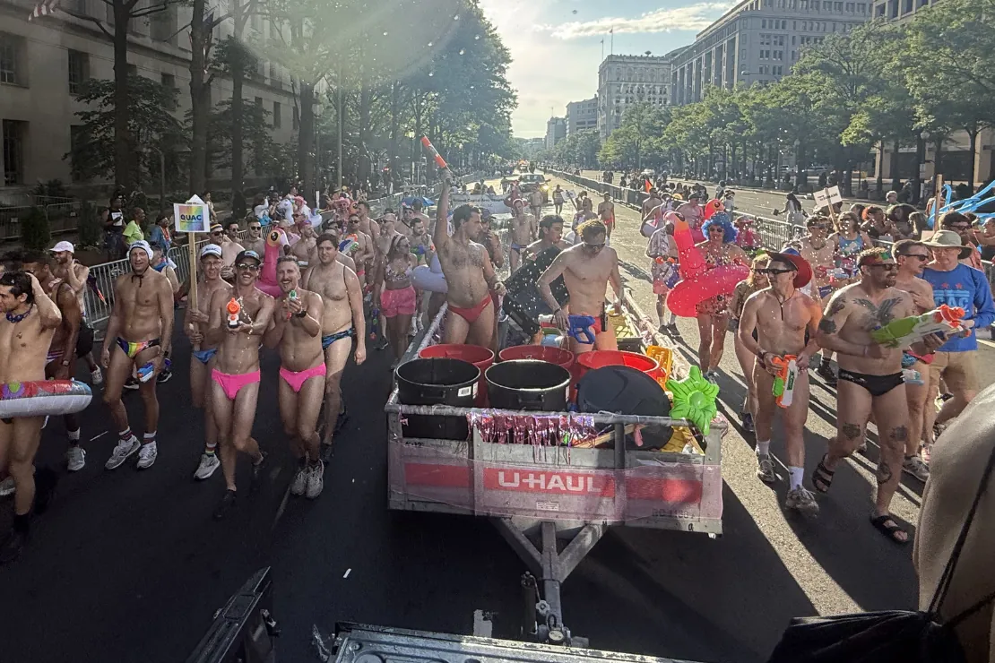 DCAC swimmers marching together behind the team float at the 2025 Pride parade in Washington, DC.